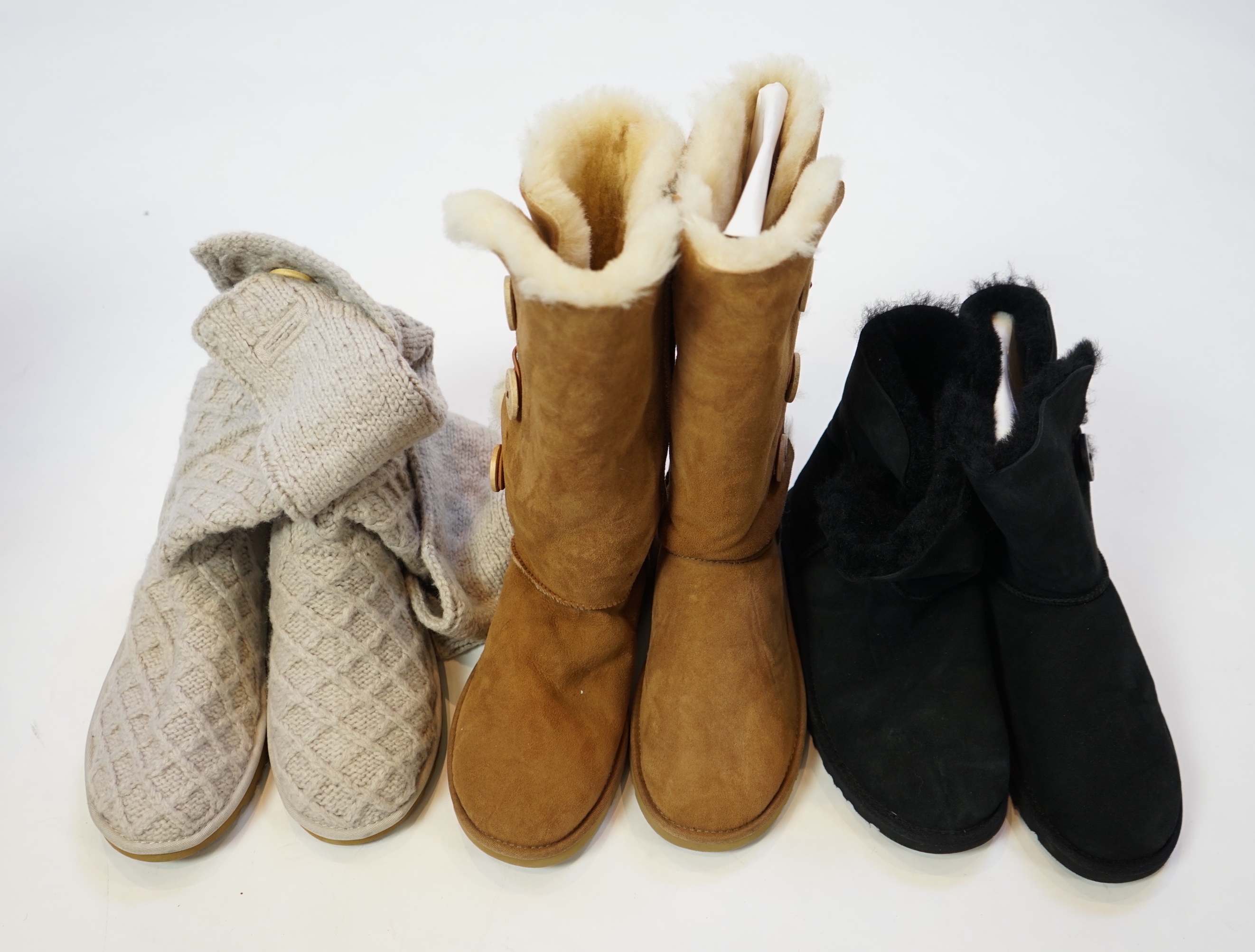 Three pairs of lady's low/mid height UGG sheepskin boots with side button design, size UK 7.5